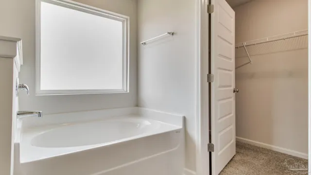 a white bath tub sitting next to a window