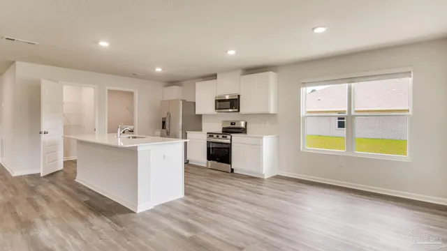 a kitchen with stainless steel appliances granite countertop a stove and a sink