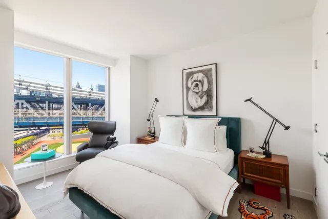 a bedroom with a bed a couch and a window