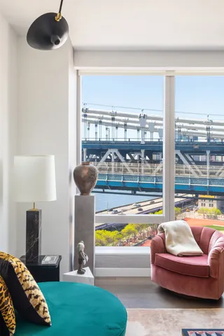 a bedroom with a bed a couch and a window