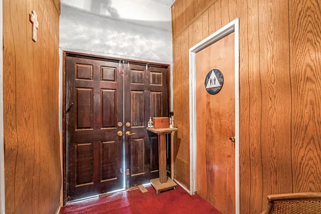 a view of a hallway with wooden door