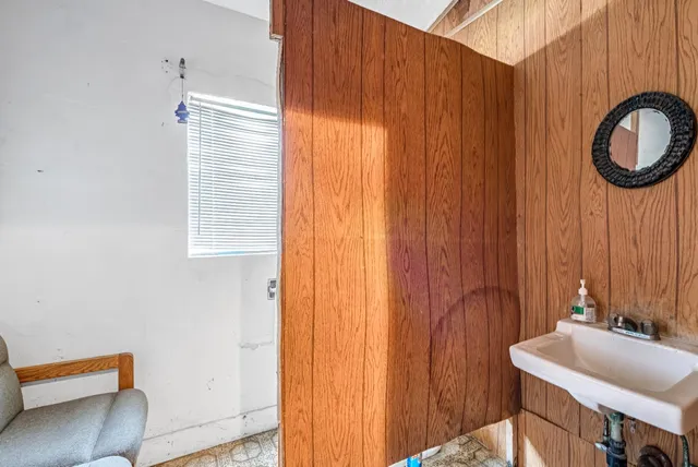 a bathroom with a sink a mirror and a shower curtain
