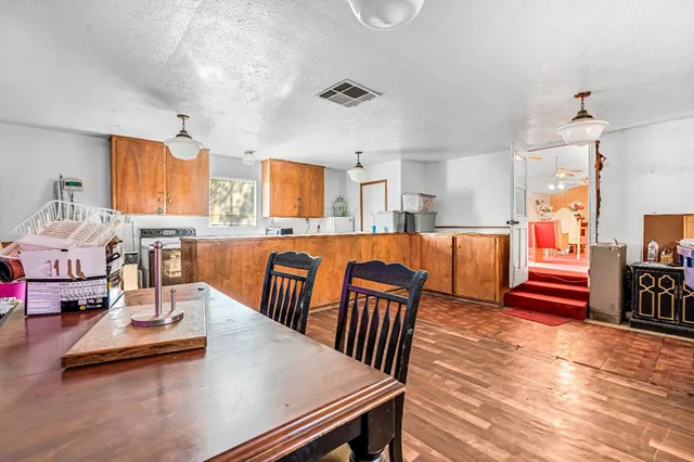a view of kitchen with dining table and chairs