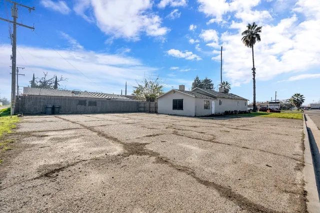 a view of a white house with a yard
