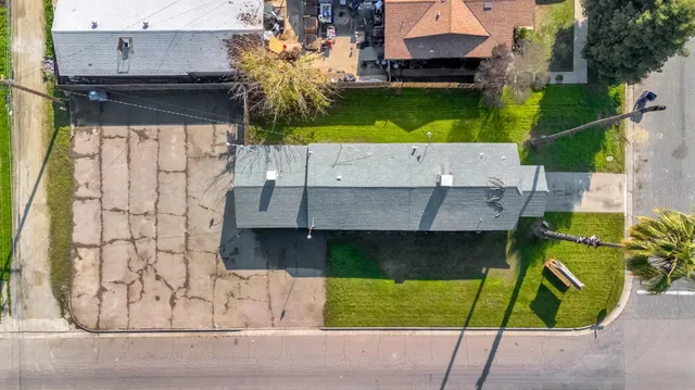 an aerial view of a house with a garden and swimming pool