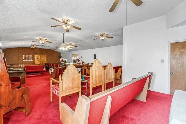 a living room with furniture pool table and chandelier