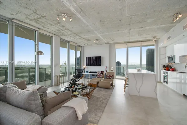 a living room with furniture and a large window