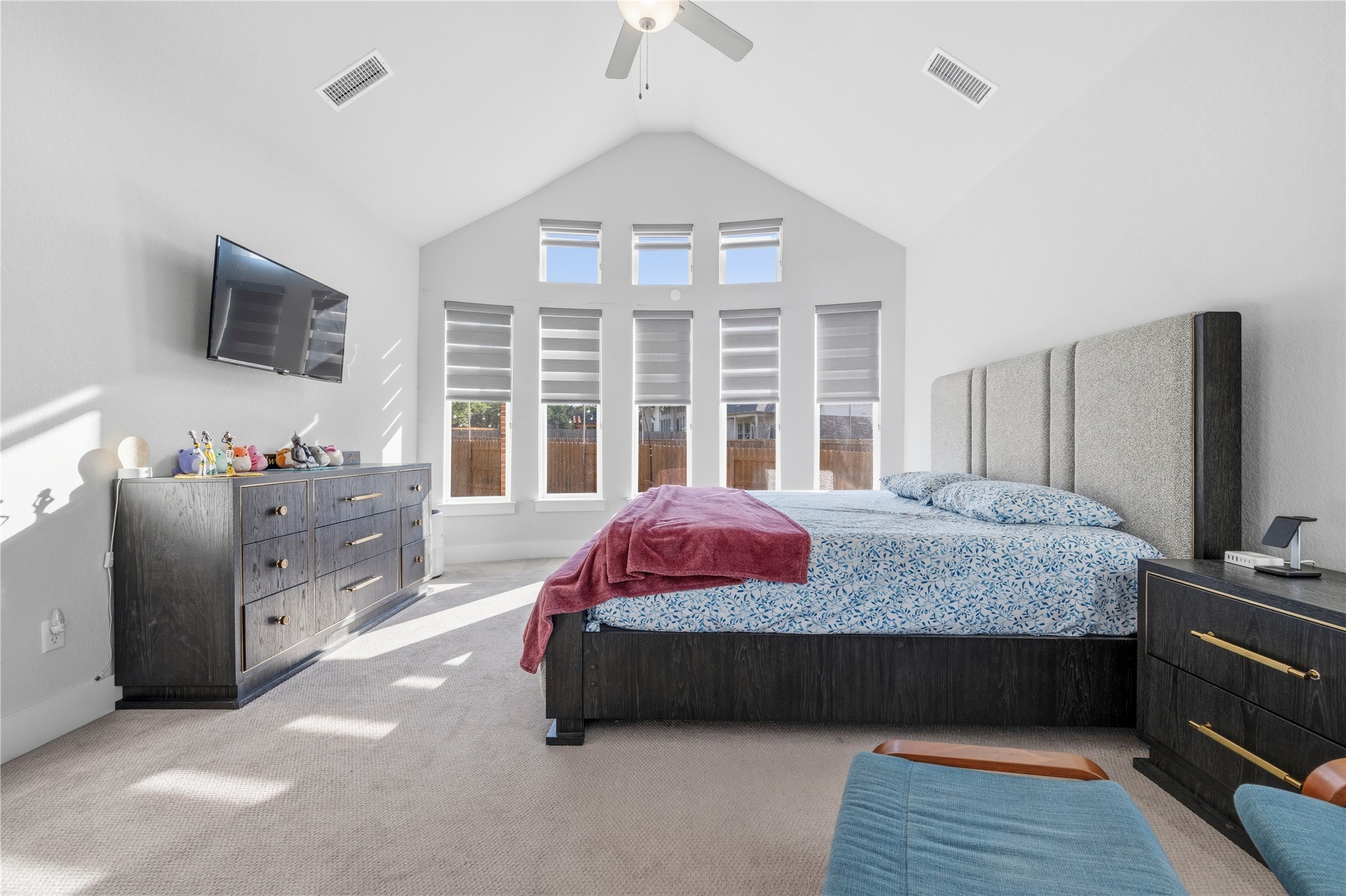 105 Autumn Oak Way Georgetown, TX 78628 - Photo 24 of 40 Vaulted ceiling bedroom with a ceiling fan, five pane windows, and light-colored carpeting