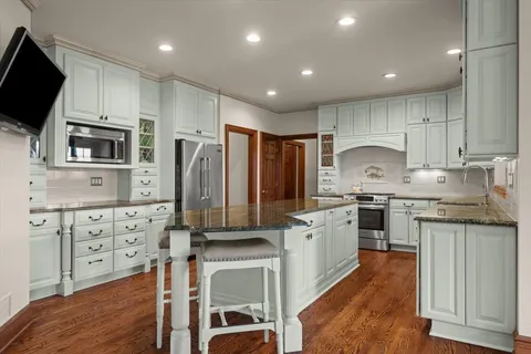 a kitchen with granite countertop cabinets and steel stainless steel appliances