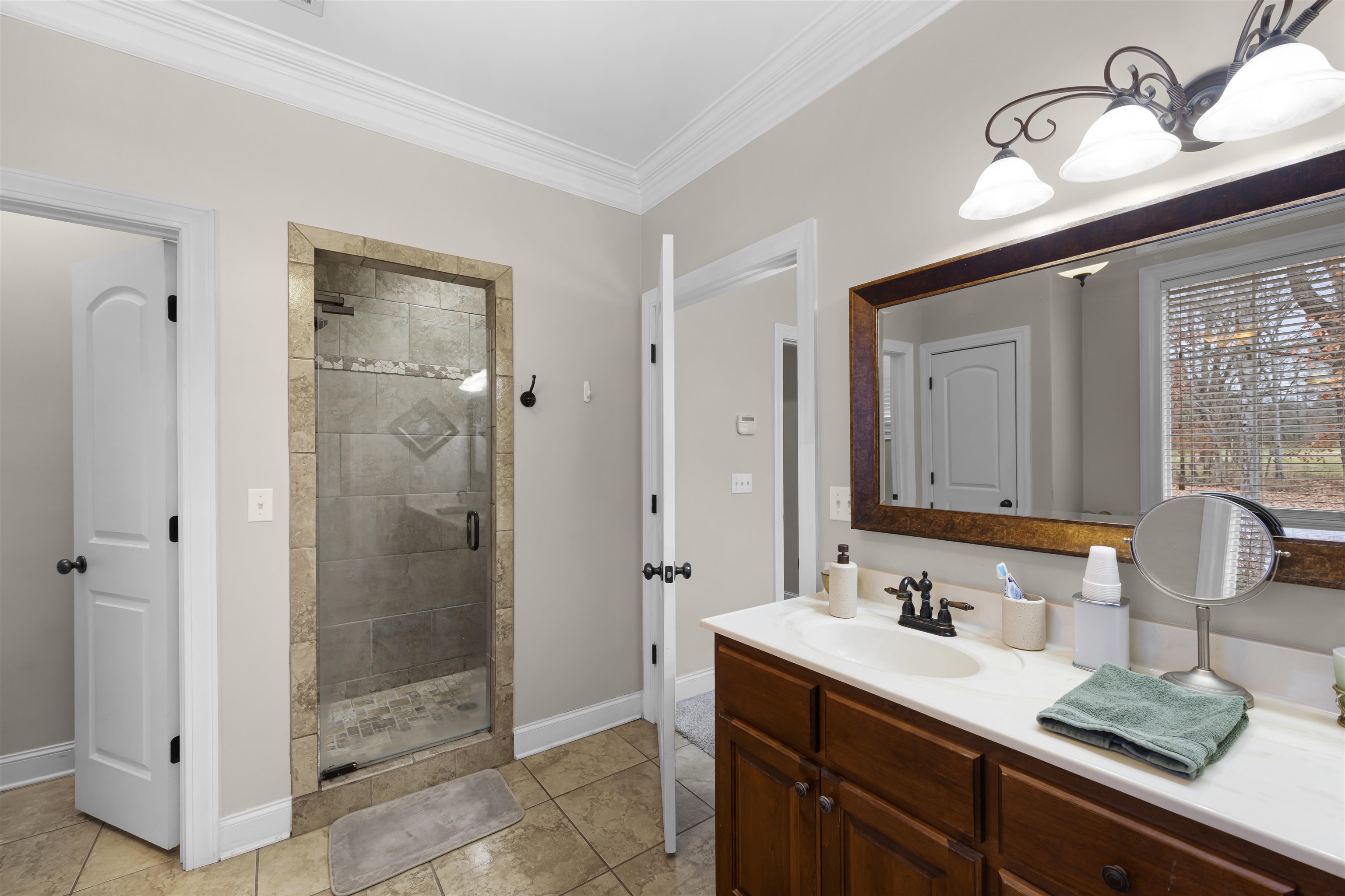 3285 Shadowood Lane Corinth, MS 38834 - Photo 18 of 31 a bathroom with a shower sink vanity granite and mirror
