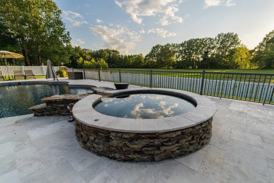 3285 Shadowood Lane Corinth, MS 38834 - Photo 28 of 31 View of pool featuring a fenced backyard, an in-ground hot tub, a patio area, and view of wooded area