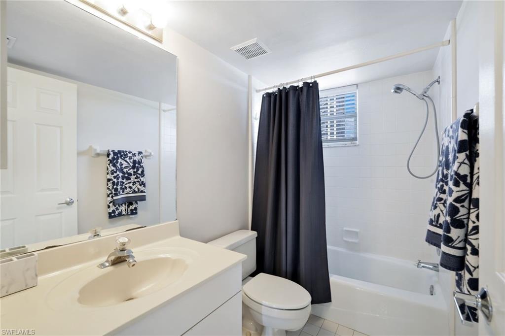 5550 Heron Point Drive, Unit 304 Naples, FL 34108 - Photo 11 of 19 a bathroom with a sink toilet and shower