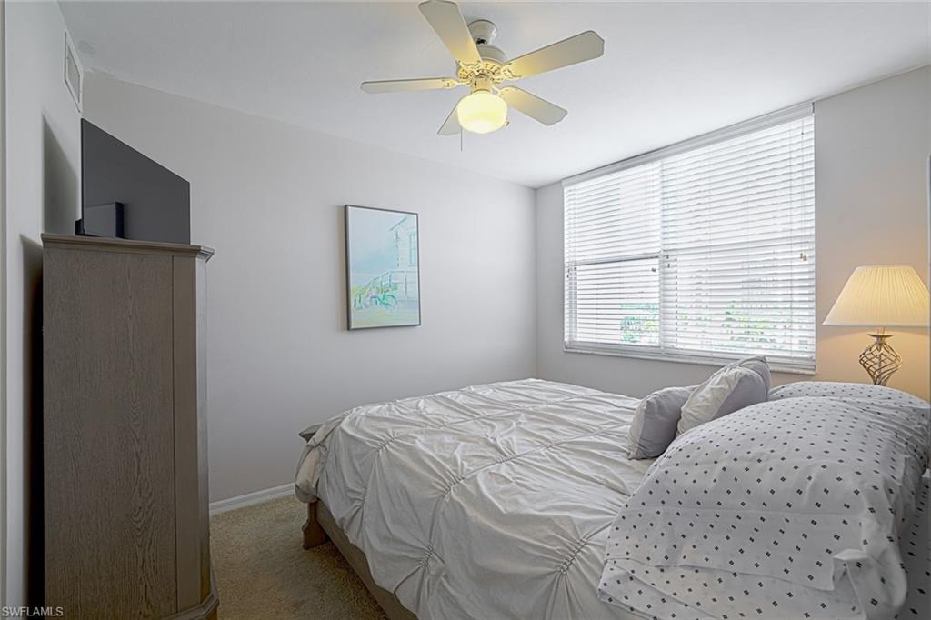 5550 Heron Point Drive, Unit 304 Naples, FL 34108 - Photo 12 of 19 a bedroom with a bed and a window