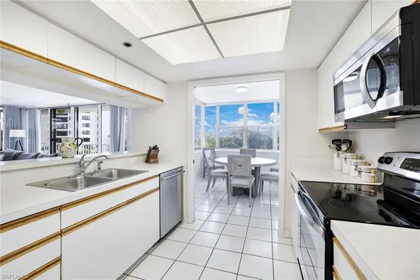 a kitchen with stainless steel appliances a sink stove and cabinets