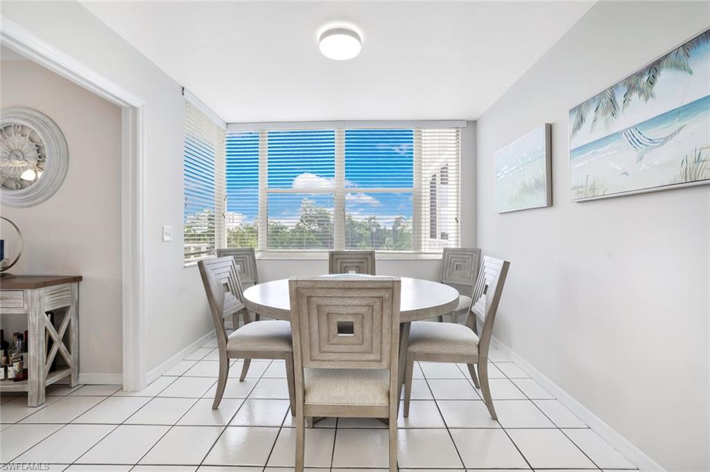 5550 Heron Point Drive, Unit 304 Naples, FL 34108 - Photo 6 of 19 a view of a dining room with furniture window and outside view