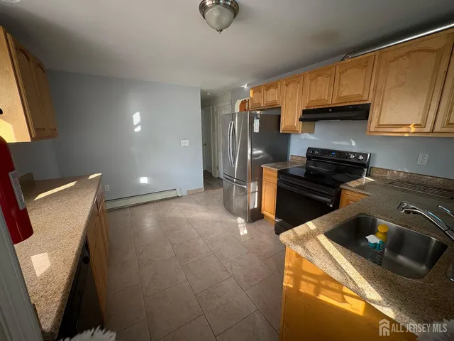 a kitchen with a refrigerator stove and sink
