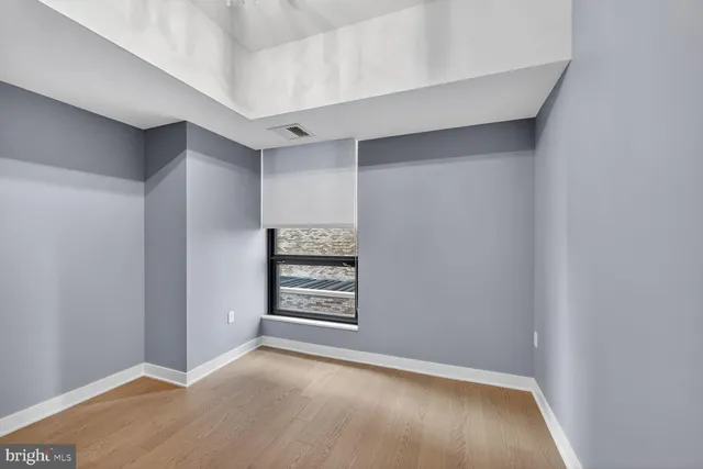 an empty room with walk in closet and window