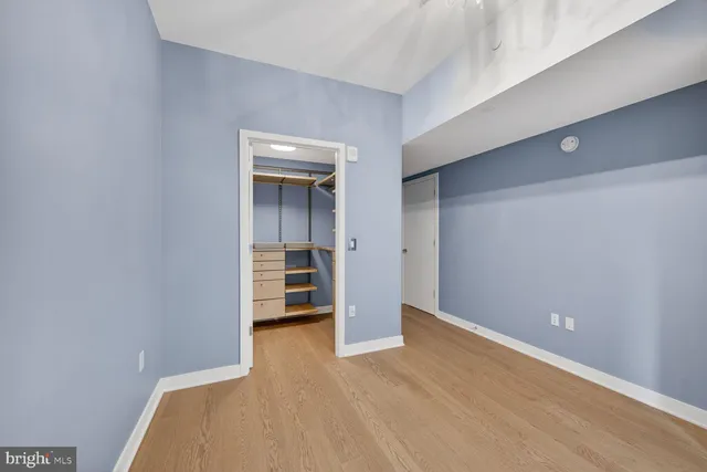a view of an empty room with a kitchen