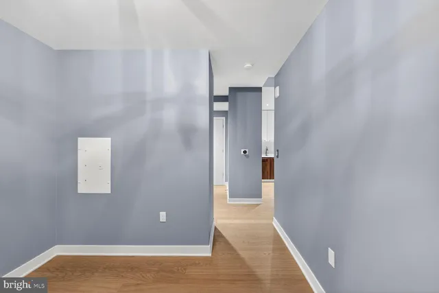 a view of a hallway with wooden floor