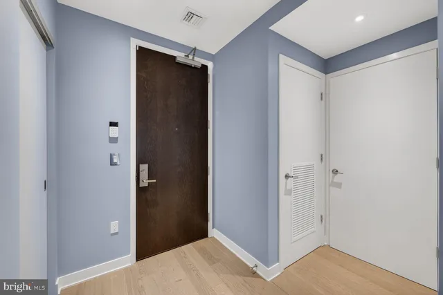 a view of hallway with wooden floor