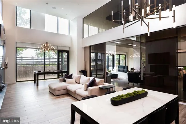 a living room with furniture and a floor to ceiling window