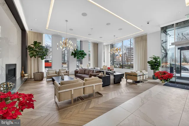 a living room with furniture fireplace and a large window