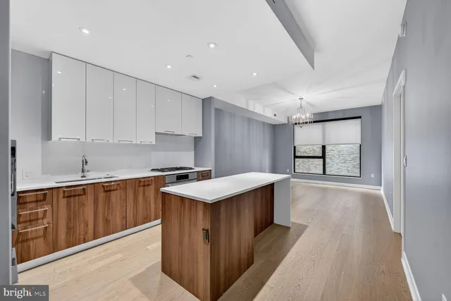 a kitchen with a sink window and cabinets