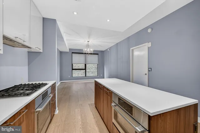 a kitchen with a stove and a refrigerator