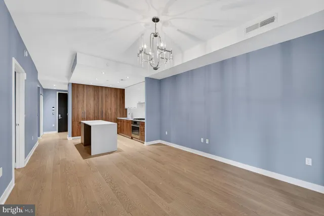 a view of a kitchen with a sink and a refrigerator