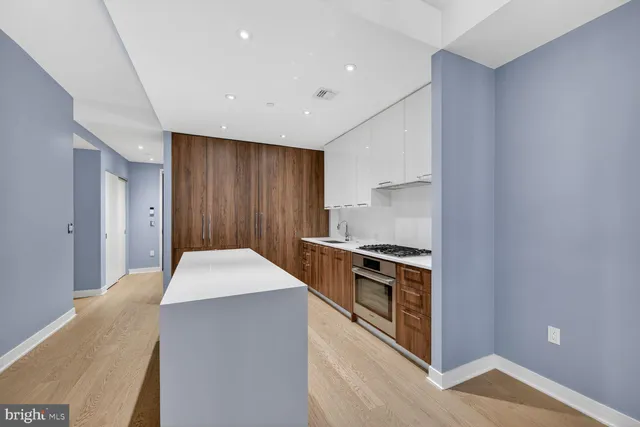 a kitchen with stainless steel appliances granite countertop a stove and a refrigerator
