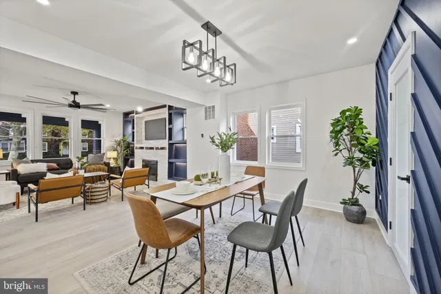 a kitchen with stainless steel appliances granite countertop a sink a stove and a wooden floors