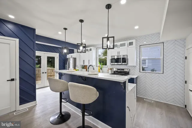 a kitchen with stainless steel appliances granite countertop a stove and a microwave