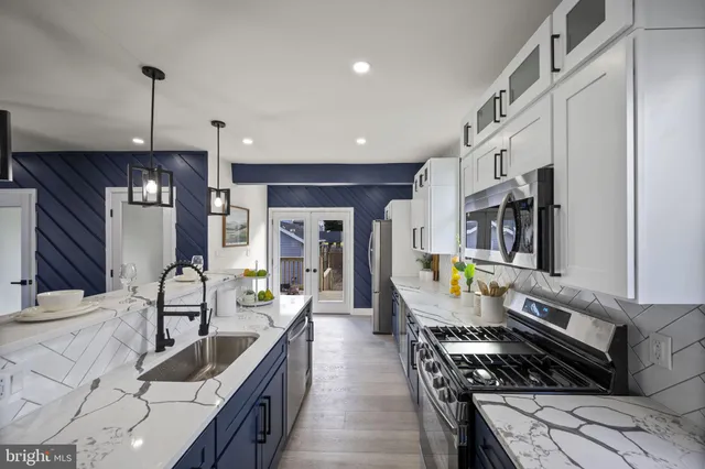 a view of a hallway with wooden floor and windows