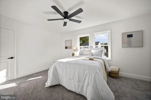 a bathroom with a toilet a sink and a large window