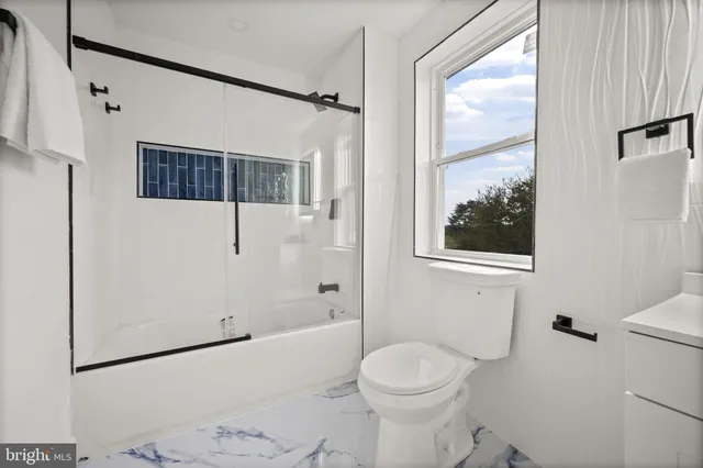 a view of small house with a garage