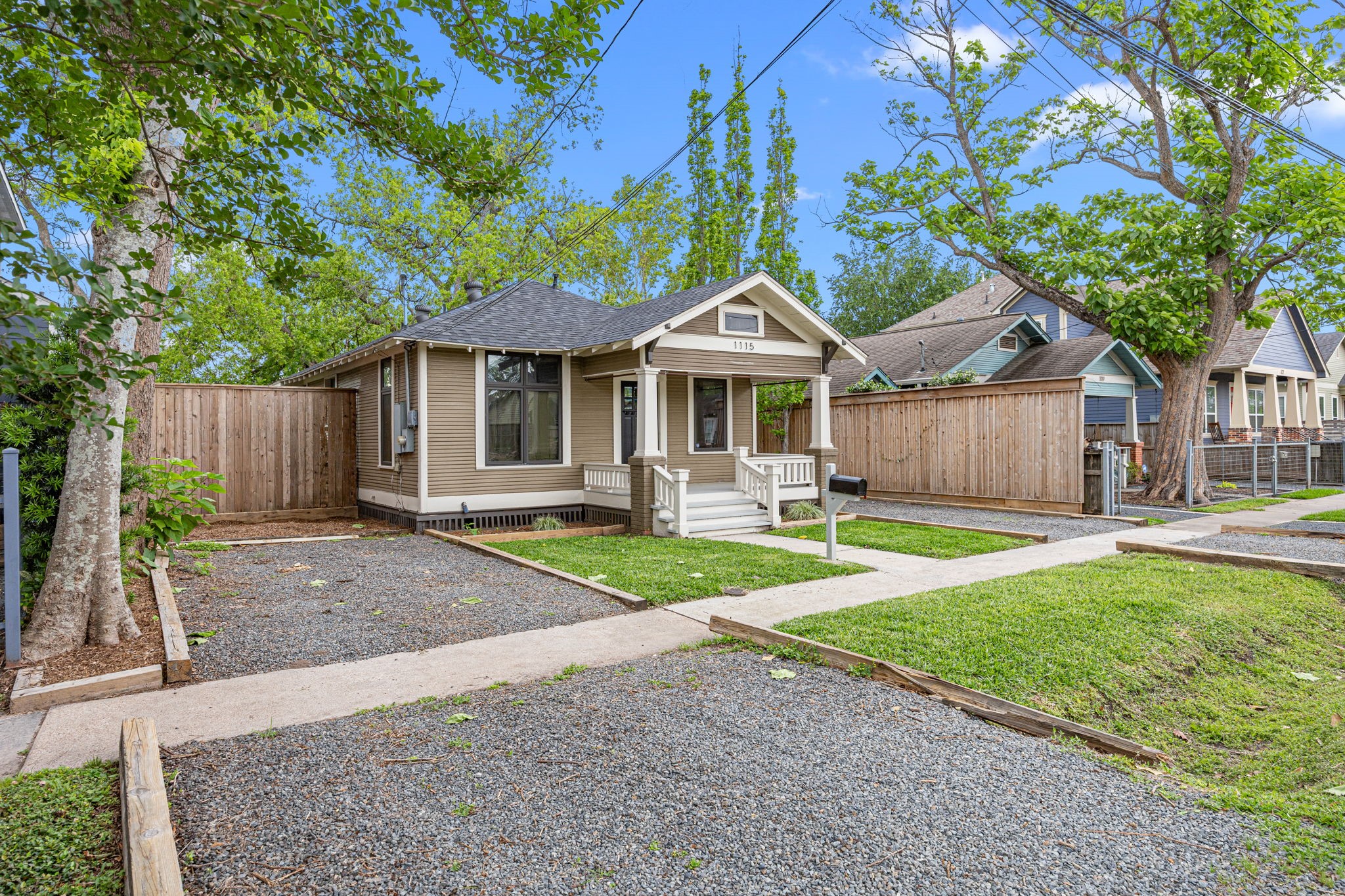 1115 Adele Street Houston, TX 77009 - Photo 18 of 19 . Charming front elevation featuring classic bungalow design, covered front porch, and mature trees.