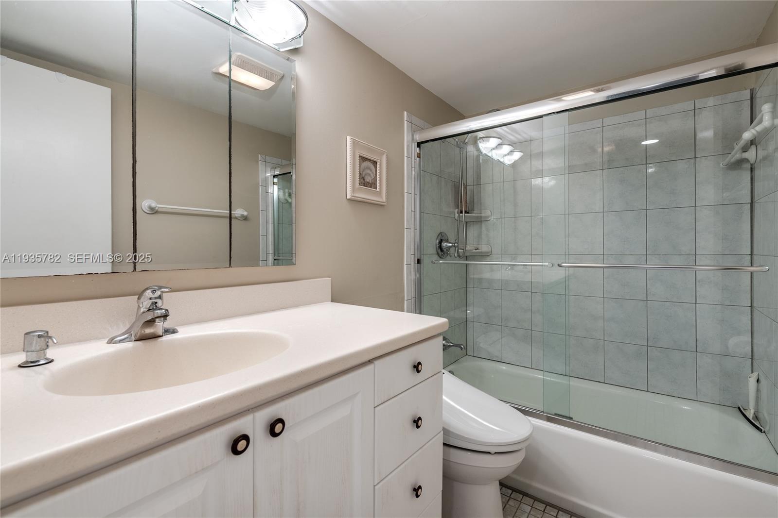 1401 South Federal Highway, Unit 122 Boca Raton, FL 33432 - Photo 8 of 20 a bathroom with a sink a toilet and shower