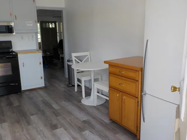 a view of a bedroom with wooden floor