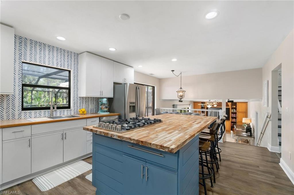1041 29th Street Southwest Naples, FL 34117 - Photo 14 of 50 a kitchen with a table and chairs in it