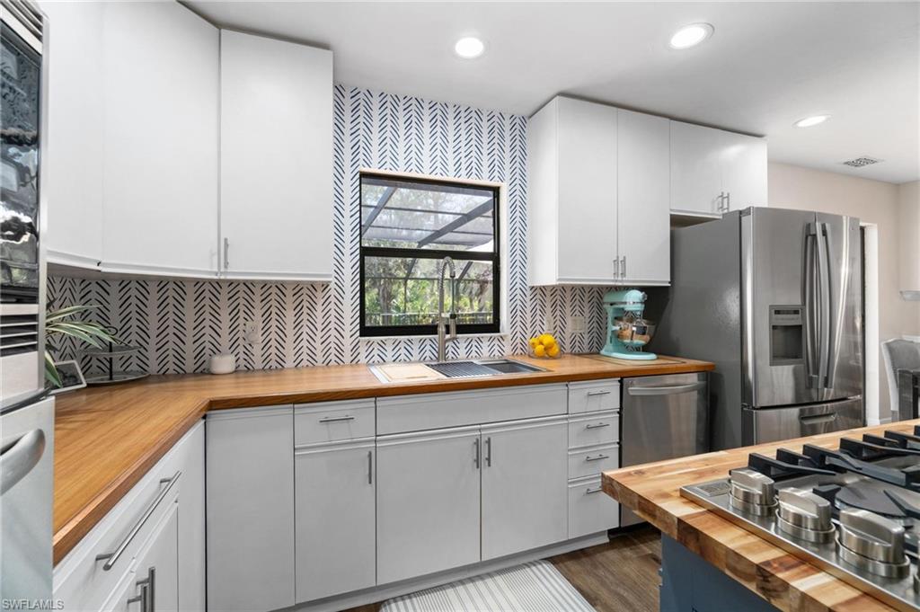 1041 29th Street Southwest Naples, FL 34117 - Photo 15 of 50 a kitchen with a sink stove and refrigerator