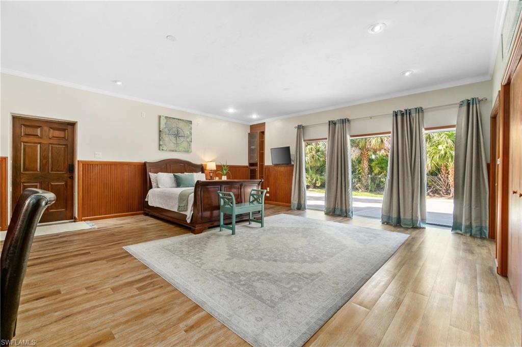 1041 29th Street Southwest Naples, FL 34117 - Photo 22 of 50 a living room with furniture and a wooden floor