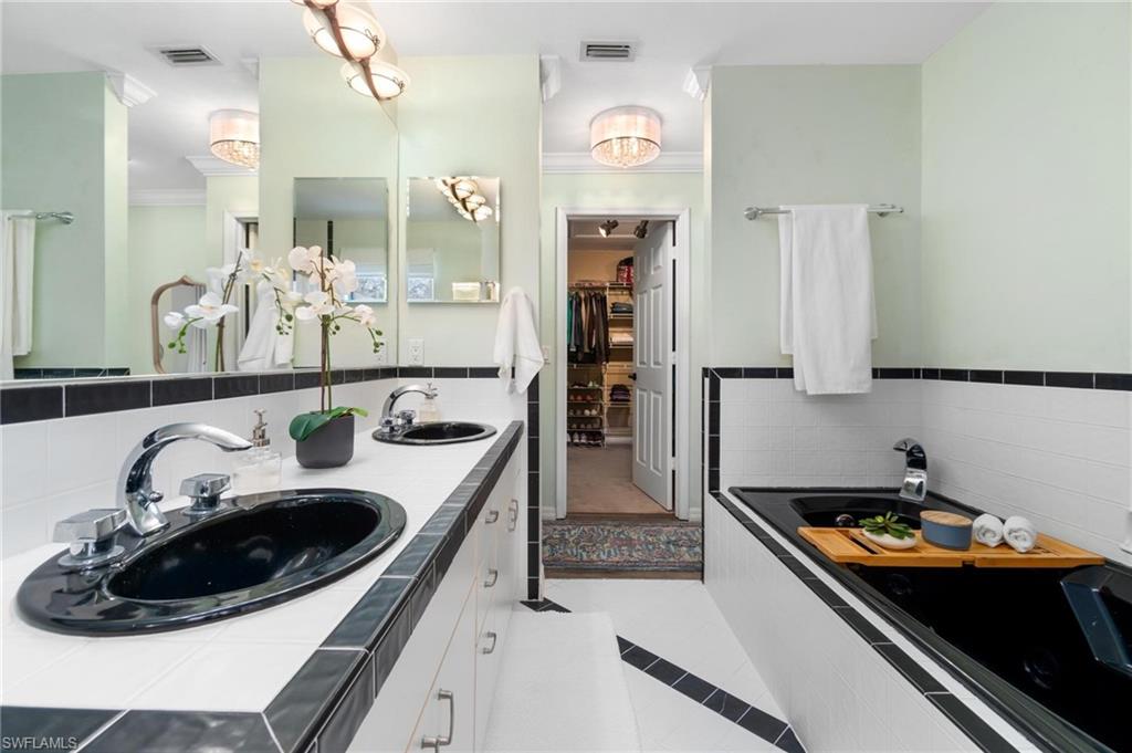 1041 29th Street Southwest Naples, FL 34117 - Photo 24 of 50 a kitchen with a sink and refrigerator