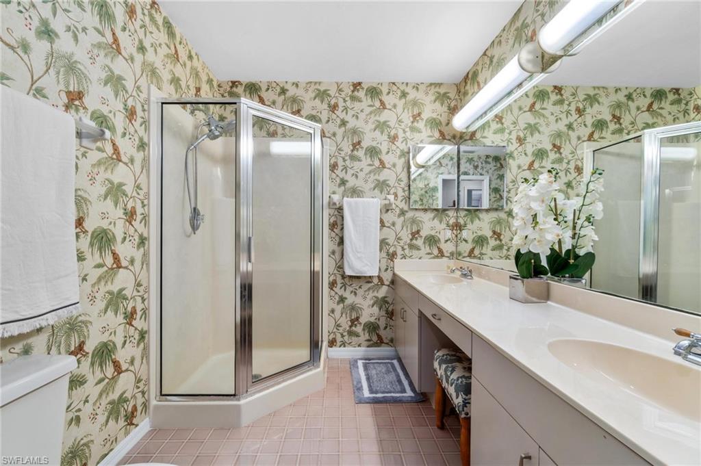 1041 29th Street Southwest Naples, FL 34117 - Photo 28 of 50 a bathroom with a double vanity sink mirror and shower