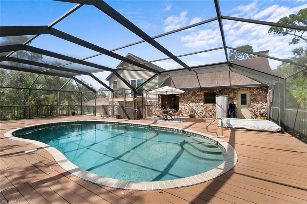 1041 29th Street Southwest Naples, FL 34117 - Photo 32 of 50 a view of a swimming pool with a patio