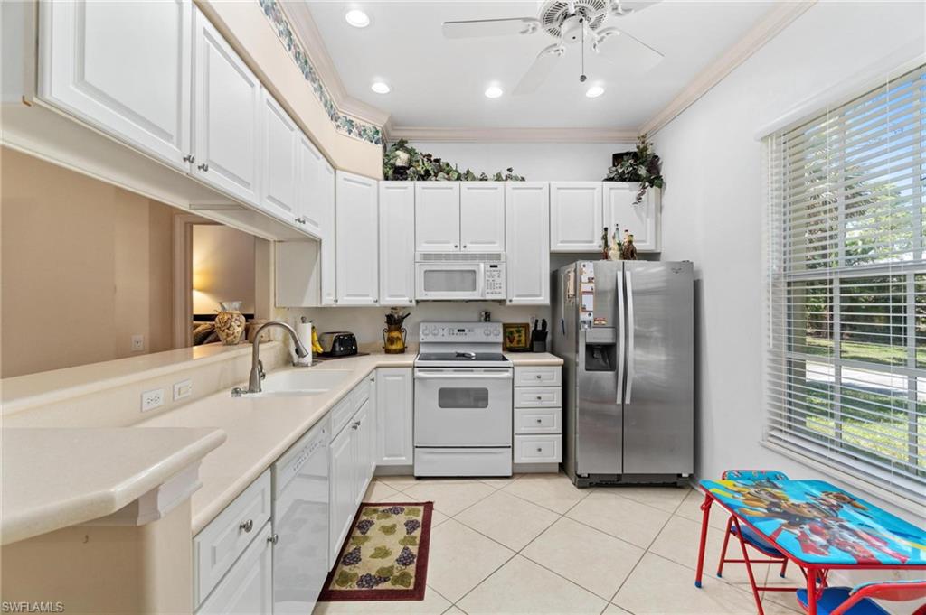 1041 29th Street Southwest Naples, FL 34117 - Photo 38 of 50 a kitchen with cabinets and stainless steel appliances