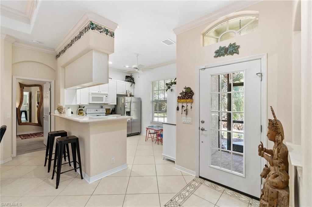 1041 29th Street Southwest Naples, FL 34117 - Photo 39 of 50 a kitchen with a refrigerator and countertop
