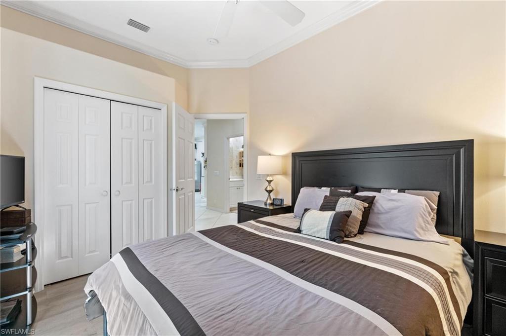 1041 29th Street Southwest Naples, FL 34117 - Photo 42 of 50 a bedroom with a bed and a tv