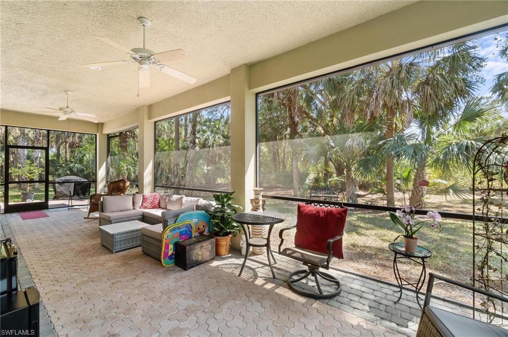 1041 29th Street Southwest Naples, FL 34117 - Photo 45 of 50 a living room with furniture and floor to ceiling windows
