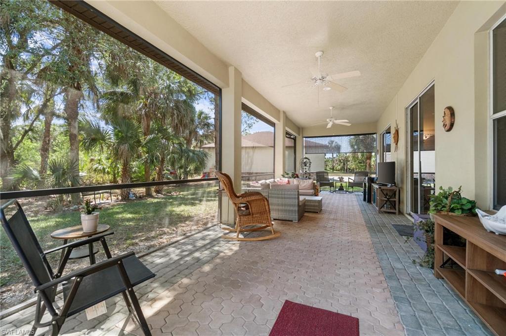 1041 29th Street Southwest Naples, FL 34117 - Photo 46 of 50 a living room with furniture and a large window