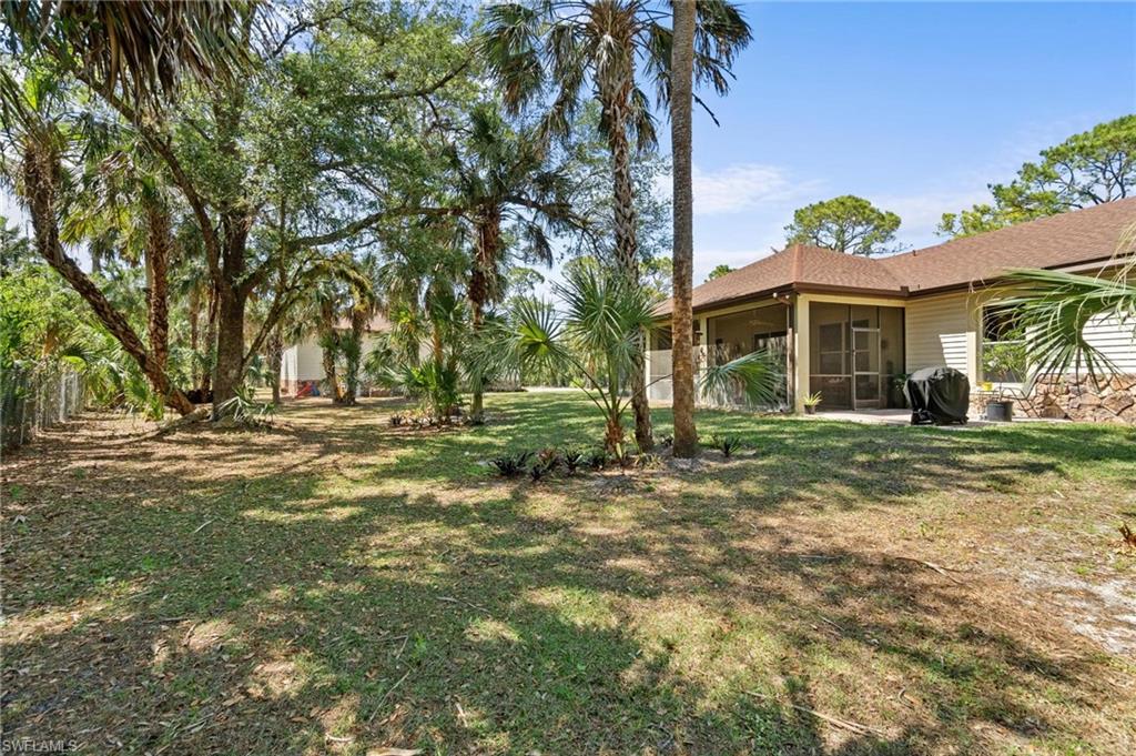 1041 29th Street Southwest Naples, FL 34117 - Photo 47 of 50 a front view of a house with a yard